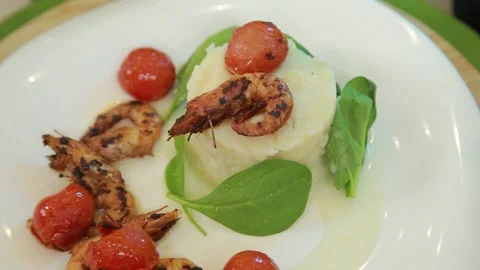Plating and presentation of celery root puree with fried shrimp and cherry tomat Stock Footage 340552240