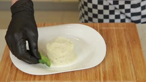 Plating and presentation of celery root puree with fried shrimp and cherry tomat Stock Footage 340552241