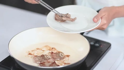 Plating Cooked Beef Ribs After Searing in a White Pan Vídeo Stock 334915655