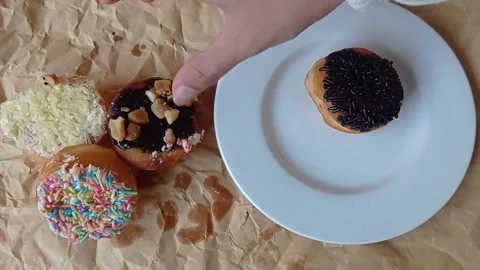Plating the donuts on a small white plate Stock Footage 149956668