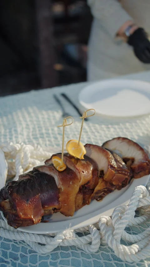Plating grilled fish slices with skewered lemon garnish Stock Footage 308472662