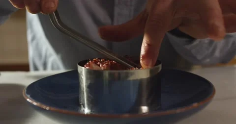 Plating octopus on plate topping with olive oil creating an octopus and potatoes Stock Footage 154849607