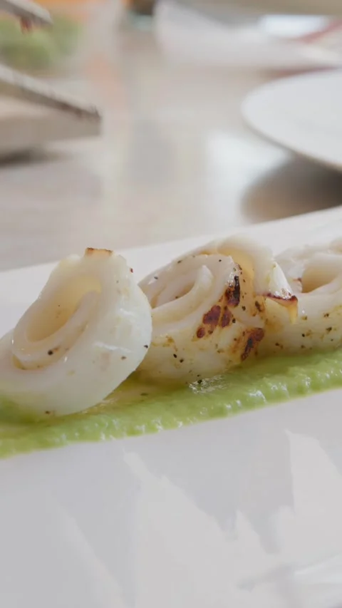 Plating a Second Course of Fish on a Green Zucchini Cream Base Stock Footage 292094251