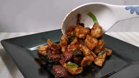 Plating the Stir Fried Vegetables on a Black Plate Stock Footage 157676443