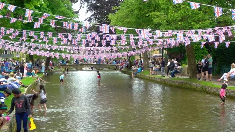 Platinum Jubilee decorations across river Windrush in Bourton on Water Stock Footage 196332804