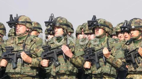 Platoon of Soldiers with Combat Military Equipment in Green Mimetic Camouflage Stock Photos