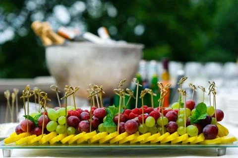 Platter of assorted fresh fruit at buffet table Stock Photos