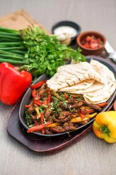 Platter of fried thin lamb slices cooked with colourful bell peppers Stock Photos