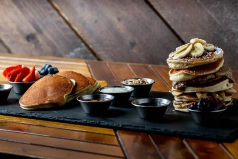 Platter of pancakes with . double large stack of protein pancakes and array of d Stock Photos