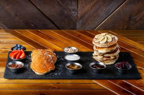 Platter of pancakes with . double large stack of protein pancakes and array of d Fotos Stock