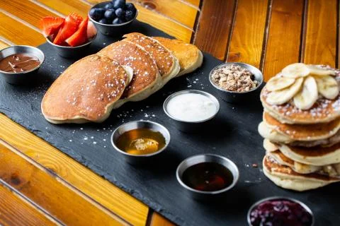 Platter of pancakes with . double large stack of protein pancakes and array of d Stock Photos