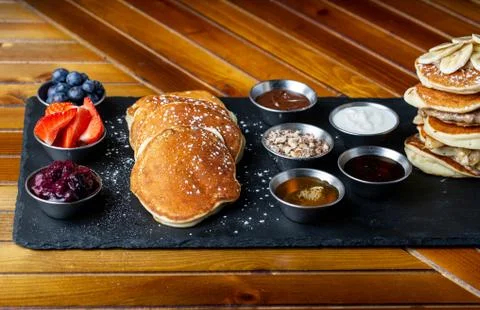 Platter of pancakes with . double large stack of protein pancakes and array of d Stock Photos