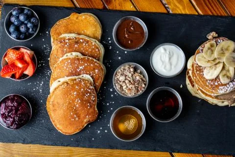 Platter of pancakes with . double large stack of protein pancakes and array of d Fotos Stock