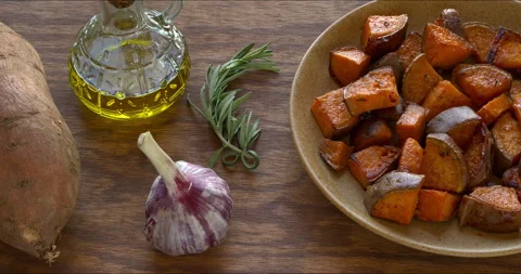 Platter of roasted sweet potatoes, main ingredients on the side. Stock Footage 312610504