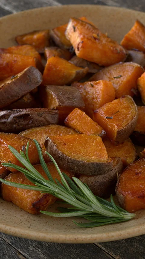 Platter of roasted sweet potatoes. Vertical video. Stock Footage 312610539