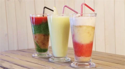 Platter of three different fruit smoothies smoothies for breakfast Stock Footage 64306829