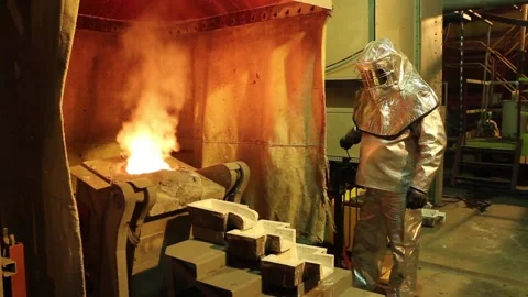 Plav 6Workers in refractory suits melt gold. Stock Footage 122211940