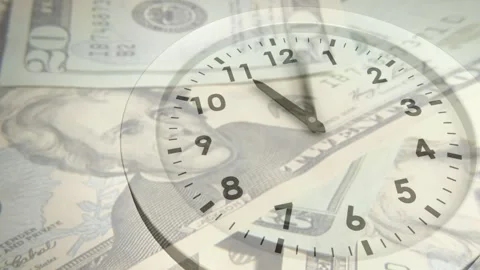 On play, analog clock face moving clockwise over layered US banknotes, showing Stock Footage 329551354
