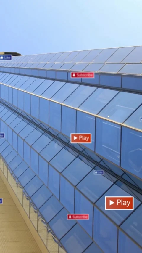 Play and subscribe buttons animation over skyscraper with reflective glass Stock Footage 342015673