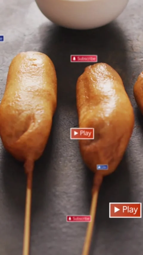 Play button appearing, overlays appearing over corn dogs, bowl revealing sauce, Stock Footage 330919535