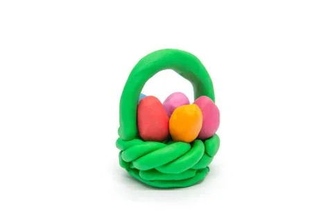 Play dough easter eggs in basket on white background Stock Photos