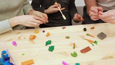 Play Dough Modelling Clay,  Mom's, Dad's and son's hands  close up Stock-Footage 102237457