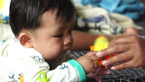Play is an essential daily routine for a baby's development. Stock Footage 302813759