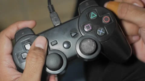 Play games on a console or computer using a controller or joystick Vídeos de archivo 241996316