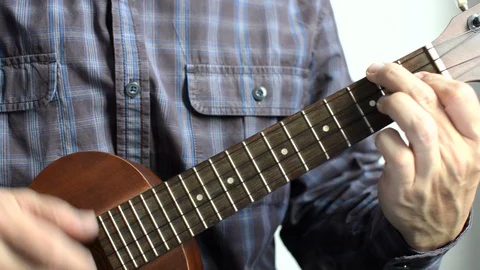 Play guitar ukulele Stock Footage 108547398