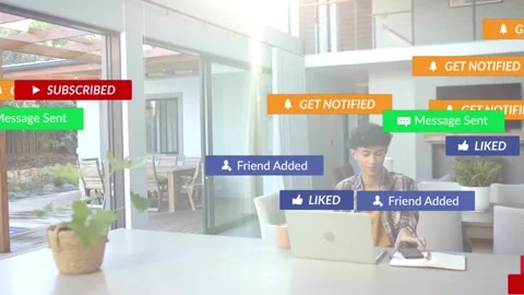 Play icon appearing triggers alerts cascading over laptop, man working, showing Stock Footage 333670631
