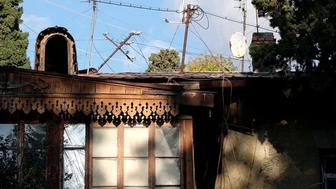 The play of light and shadow on an old wooden house with a satellite dish Stock Footage 84075533