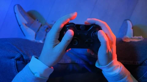 Play the PS4 Station controller in the hands of gamer. Young man is playing a 스톡 동영상 118395379