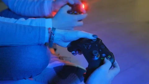 Play the PS4 Station controller in the hands of gamers. Young couple man with a Stock Footage