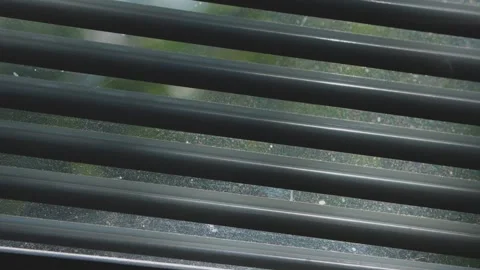 The play of shadows on closed blinds and glass with multi-colored dust Stock Footage 336802200