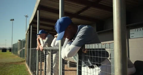 Play unfolding prompting diverse baseball teammates cheering and slumping on Stock Footage 340972278