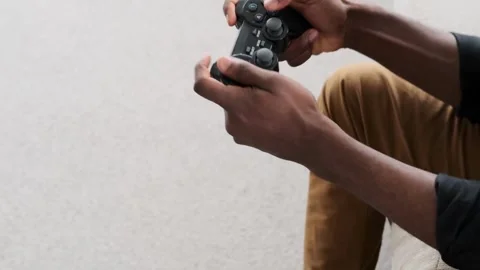 Play the video game theme. Man playing video games holding a joystick 스톡 동영상 334653609