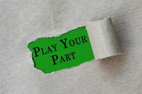 Play your part text on torn hole in the sheet of brown paper on green backgro Stock Photos