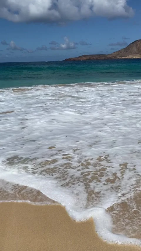Playa de las Conchas with turquoise waters and golden sands in La Graciosa Stock Footage 310557452