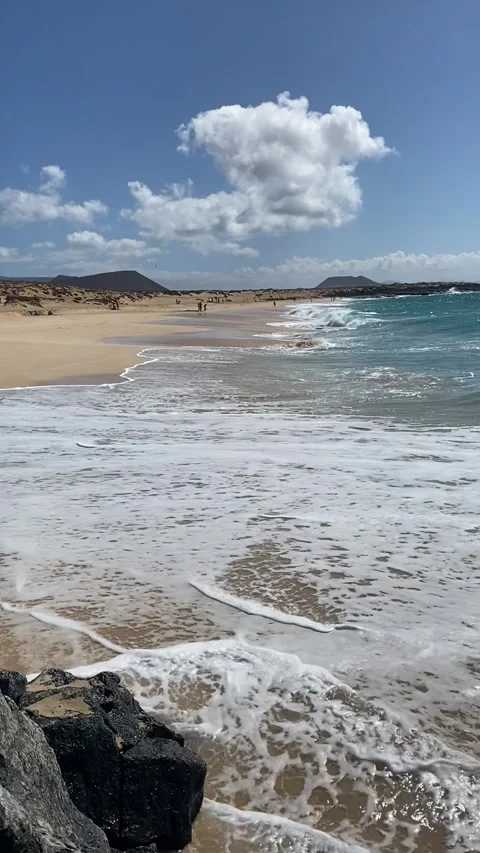 Playa de las Conchas with wild waves and sandy beach on La Graciosa Stock Footage 310574035