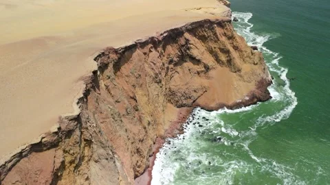 Playa Roja dramatic sand cliffs and red beach Paracas Peru aerial ocean view Stockbeeldmateriaal 318281567