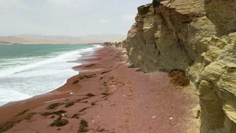 Playa Roja red sand beach vibrant ocean and coastal cliffs Paracas Peru aerial Stock Footage 318282497