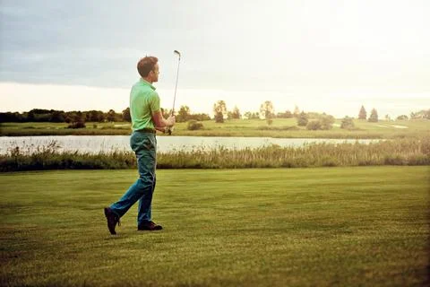 Played like a pro. a man practicing his swing on the golf course. Stock Photos