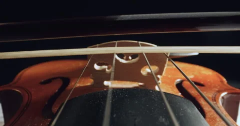 Played on violin with bow moving and strings vibrating in super slow motion Stock Footage 319884067