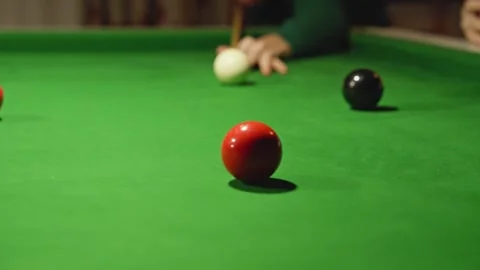 Player aiming red ball with white ball on snooker table Stock Footage 318179046