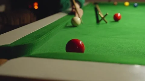 Player aiming white ball to hit red ball on snooker table Stock Footage 318178149