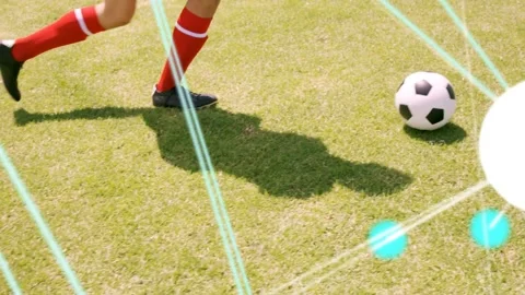 Player at ball nudging forward on grass, teal lines, white circle over right Stock Footage 334369369