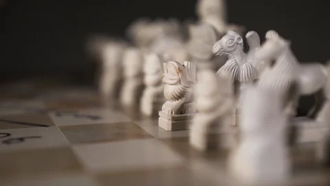 Player chess opposite side hand closeup make first strategic move black 4K pawn. Stock Footage 119073197