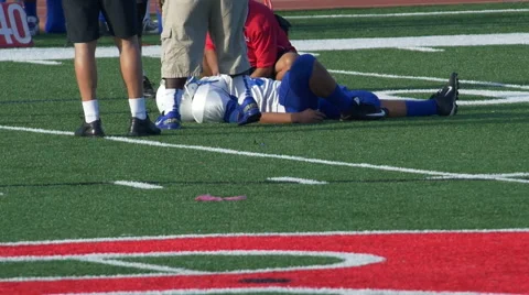 A player is injured while playing American football. Stock Footage