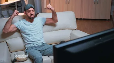 Player man holding wireless controller while playing videogames Stock Photos