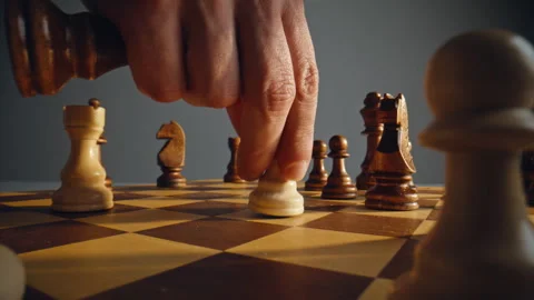 Player moving chess pieces chessboard closeup. Hand advancing single white unit Stock Footage 332310381